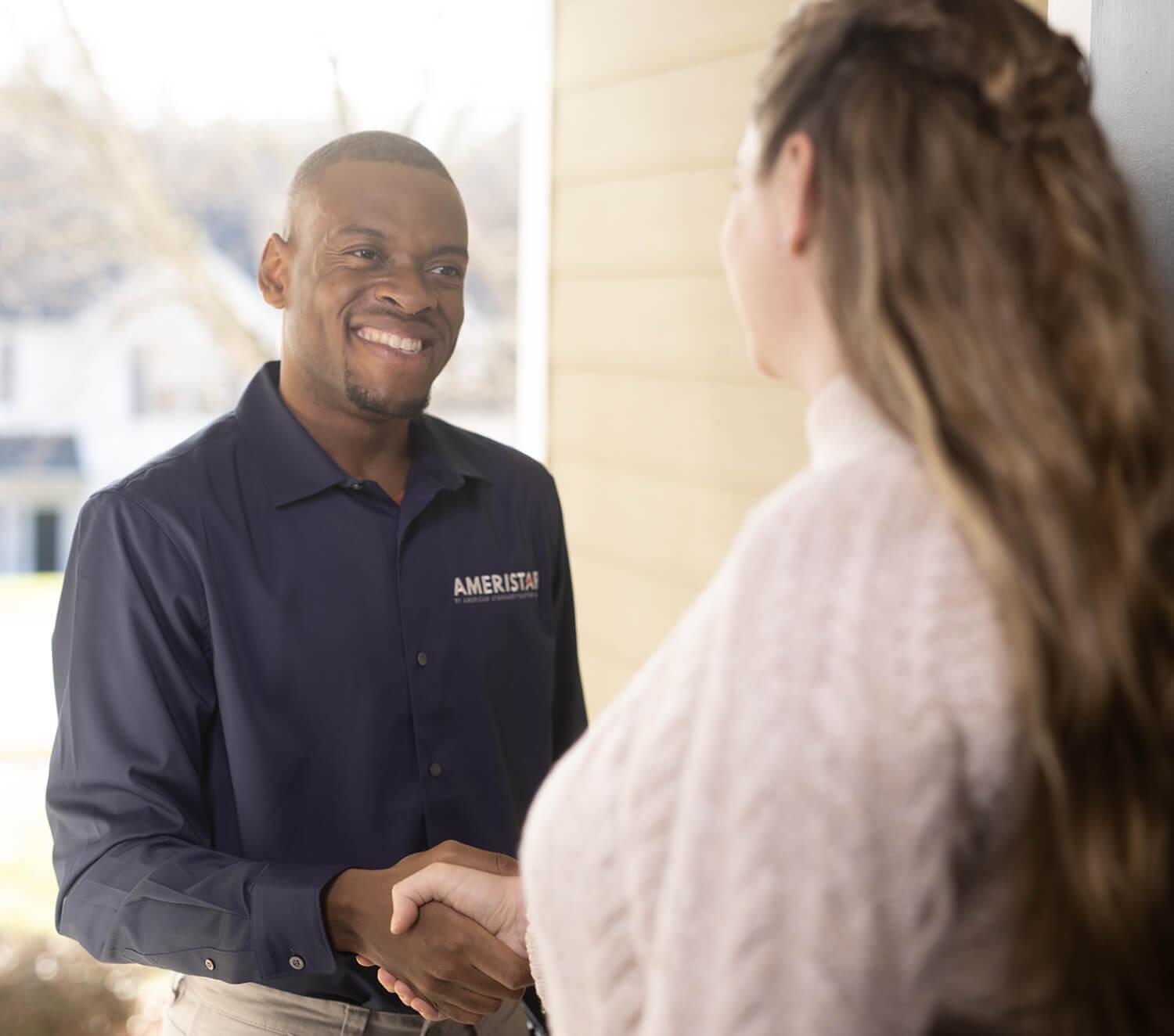 man shaking woman's hand