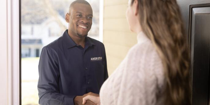 man shaking woman's hand